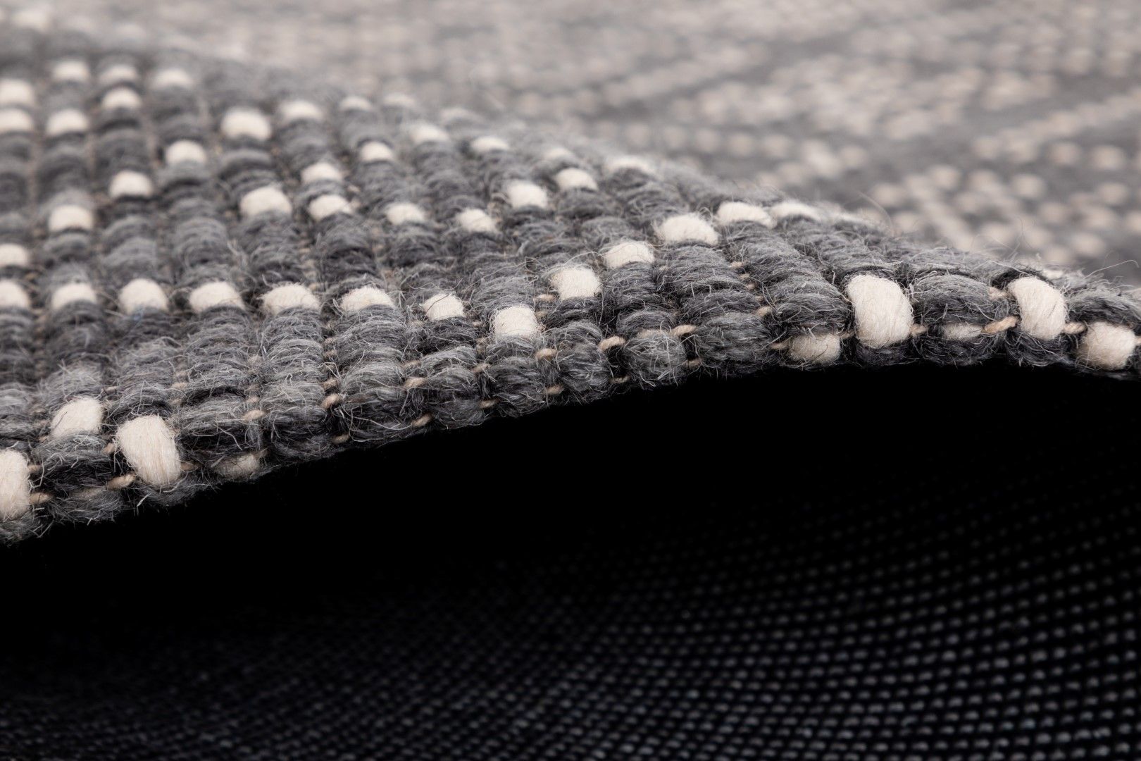 Bellevue Grey is a textured hand woven  wool and viscose rug.  Featuring a tribal diamond aztec design. Colours Grey with White Patterns. Sizes 155 X 225, 200 X 290 and 300 X 400. Side.