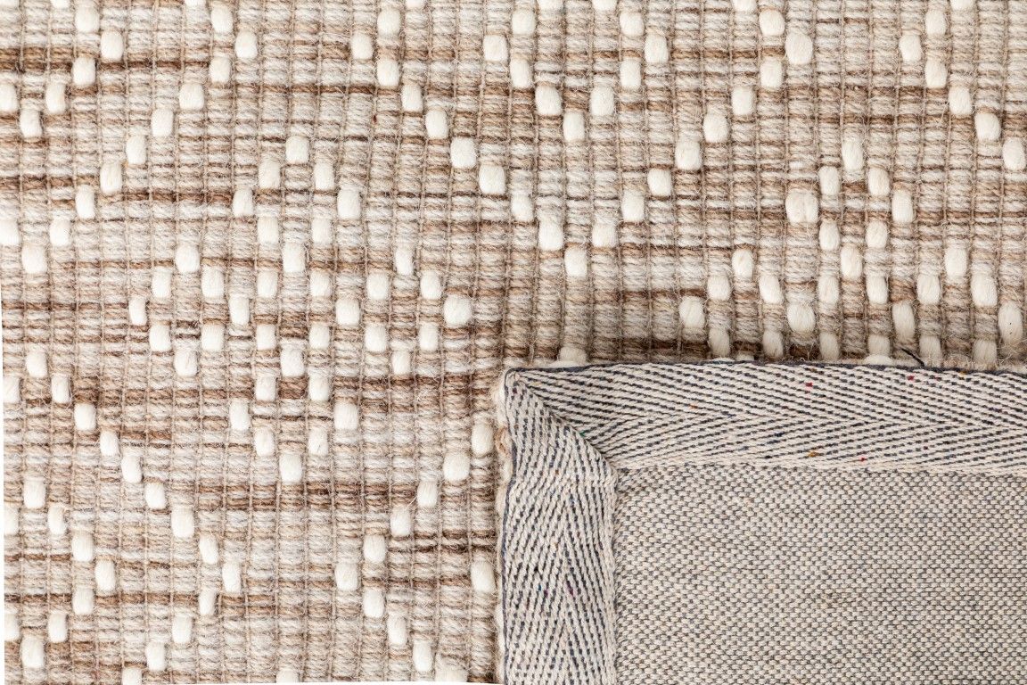 Bellevue Natural is a textured hand woven  wool and viscose rug.  Featuring a tribal diamond aztec design. Colours Beige/Cream with White Patterns. Size 300 X 400. Fold.