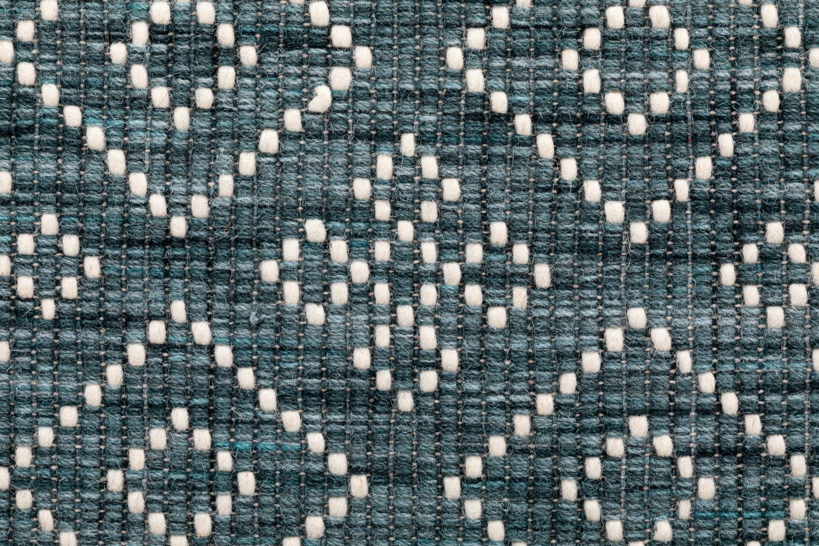 Bellevue Teal is a textured hand woven  wool and viscose rug.  Featuring a tribal diamond aztec design. Colours Teal Green with White Patterns. Sizes 200 X 290 and 300 X 400. Close.