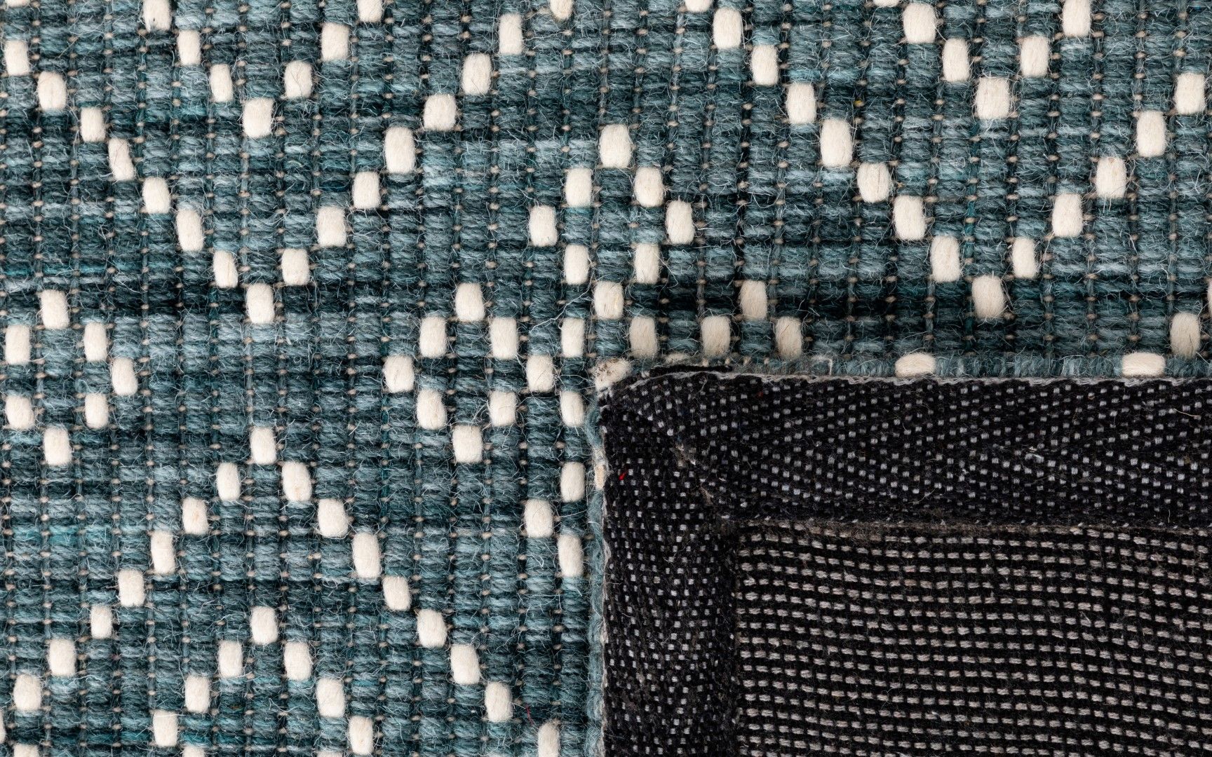 Bellevue Teal is a textured hand woven  wool and viscose rug.  Featuring a tribal diamond aztec design. Colours Teal Green with White Patterns. Sizes 200 X 290 and 300 X 400. Fold.