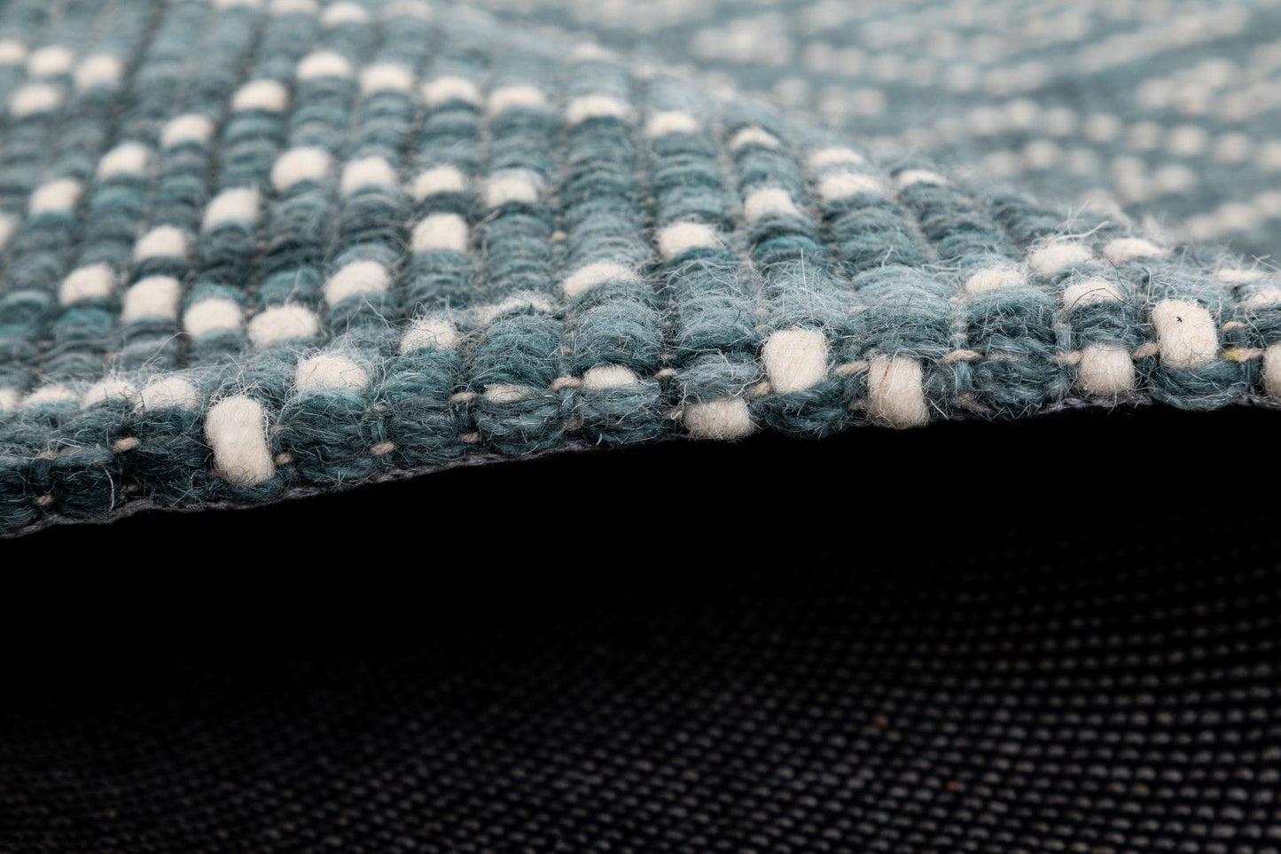 Bellevue Teal is a textured hand woven  wool and viscose rug.  Featuring a tribal diamond aztec design. Colours Teal Green with White Patterns. Sizes 200 X 290 and 300 X 400. Side.