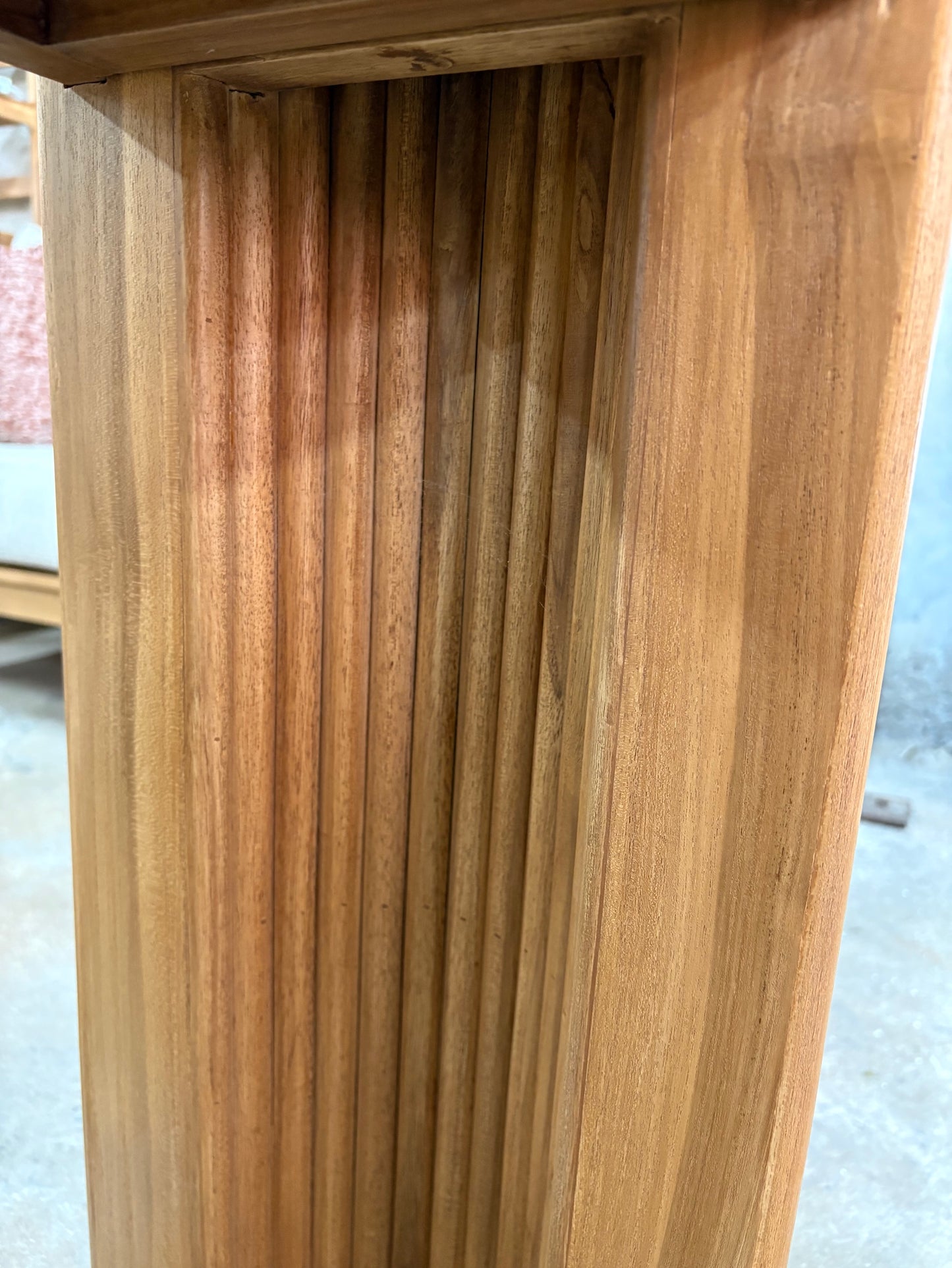 Berlin Teak Top Console crafted from solid teak. Featuring solid teak top with rounded ends and solid fluted pillar supports. Colour Natural Teak. Measures 1600 Wide X 350 Depth X 7500 Height. Inside Leg.