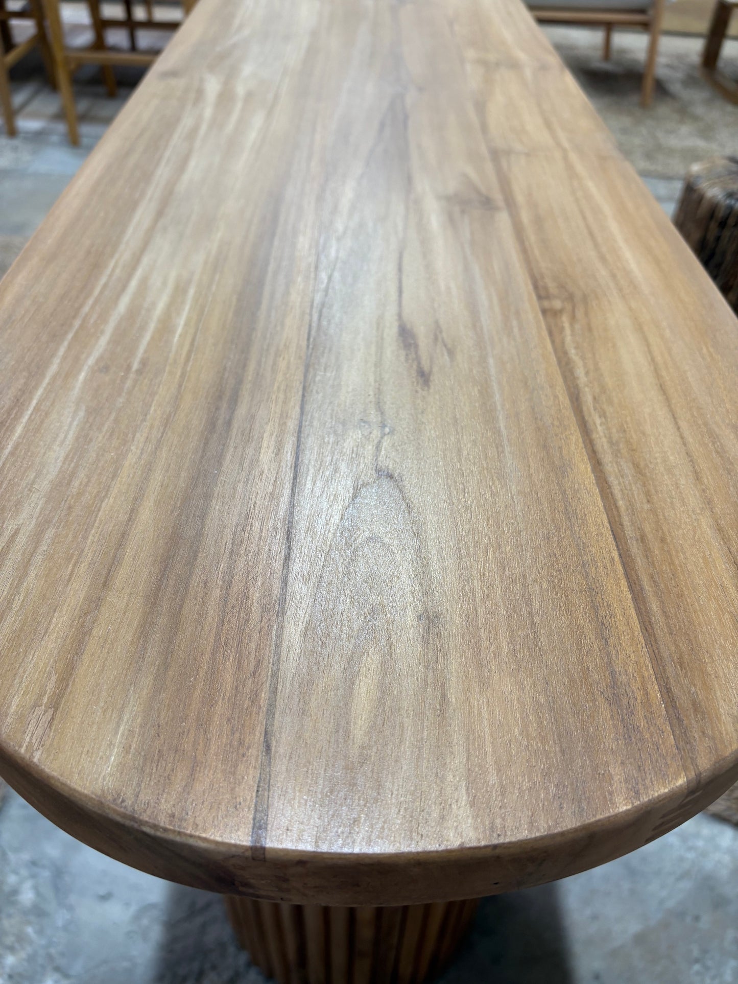 Berlin Teak Top Console crafted from solid teak. Featuring solid teak top with rounded ends and solid fluted pillar supports. Colour Natural Teak. Measures 1600 Wide X 350 Depth X 7500 Height. Top End.