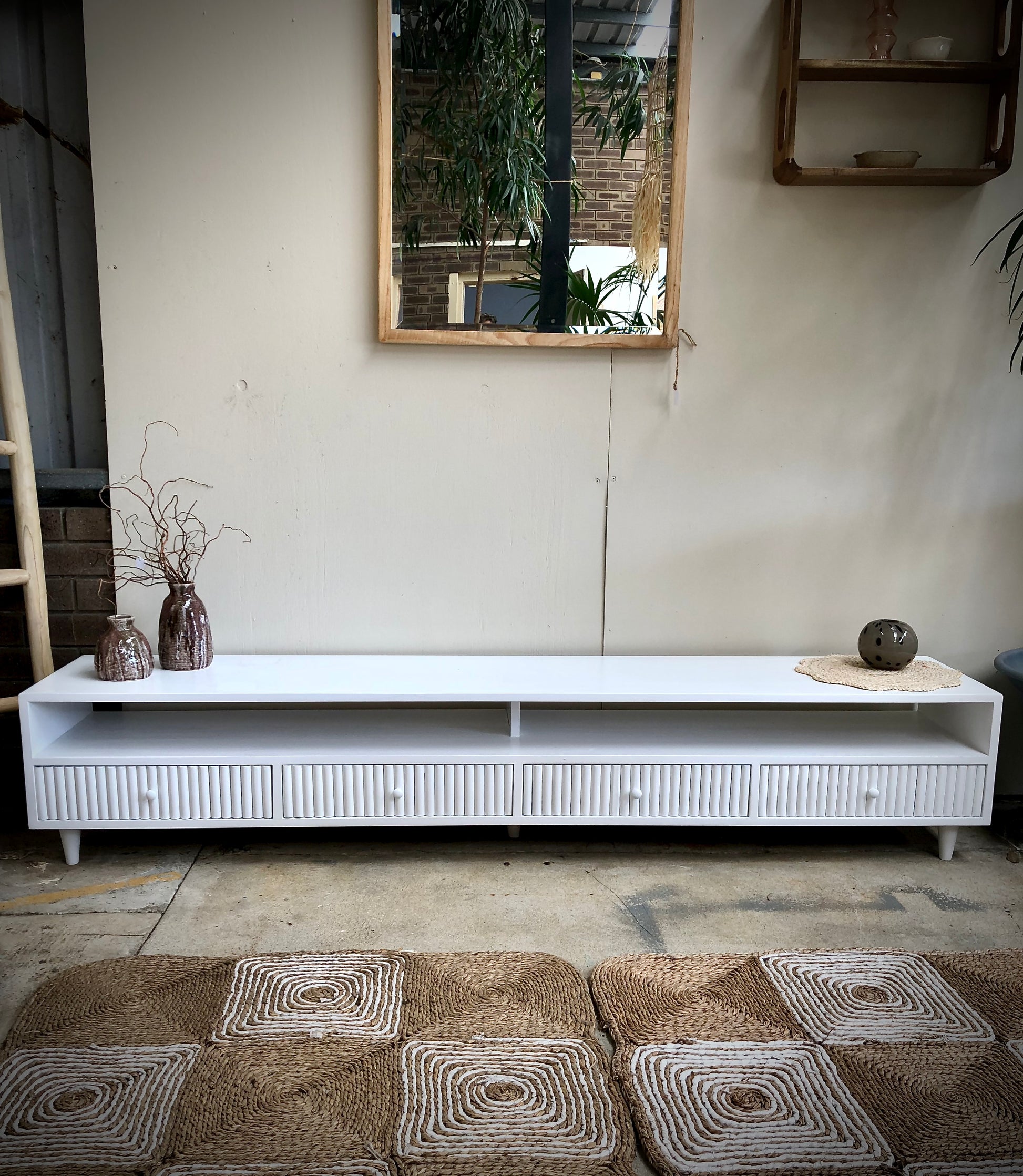 The Brando 4 Drawer White Entertainment Unit is a modern/contemporary designed piece. It has 4 textured drawers and 2 open shelves. Crafted from sustainable white cedar. Colour white. Measures 2100 length X 400 depth X 400 height. Styled.