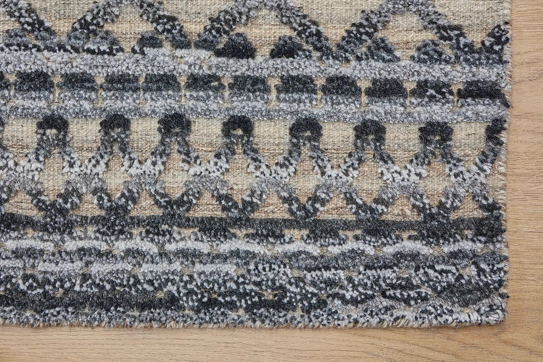 Brazil - Carbon is a Tribal Hand-Knotted Wool and Bamboo Silk Rug with a pile height of 7-9mm. Colours Dark Grey, Blues and Cream. Sizes 160 X 230, 200 X 290, and 240 X 340. Corner.
