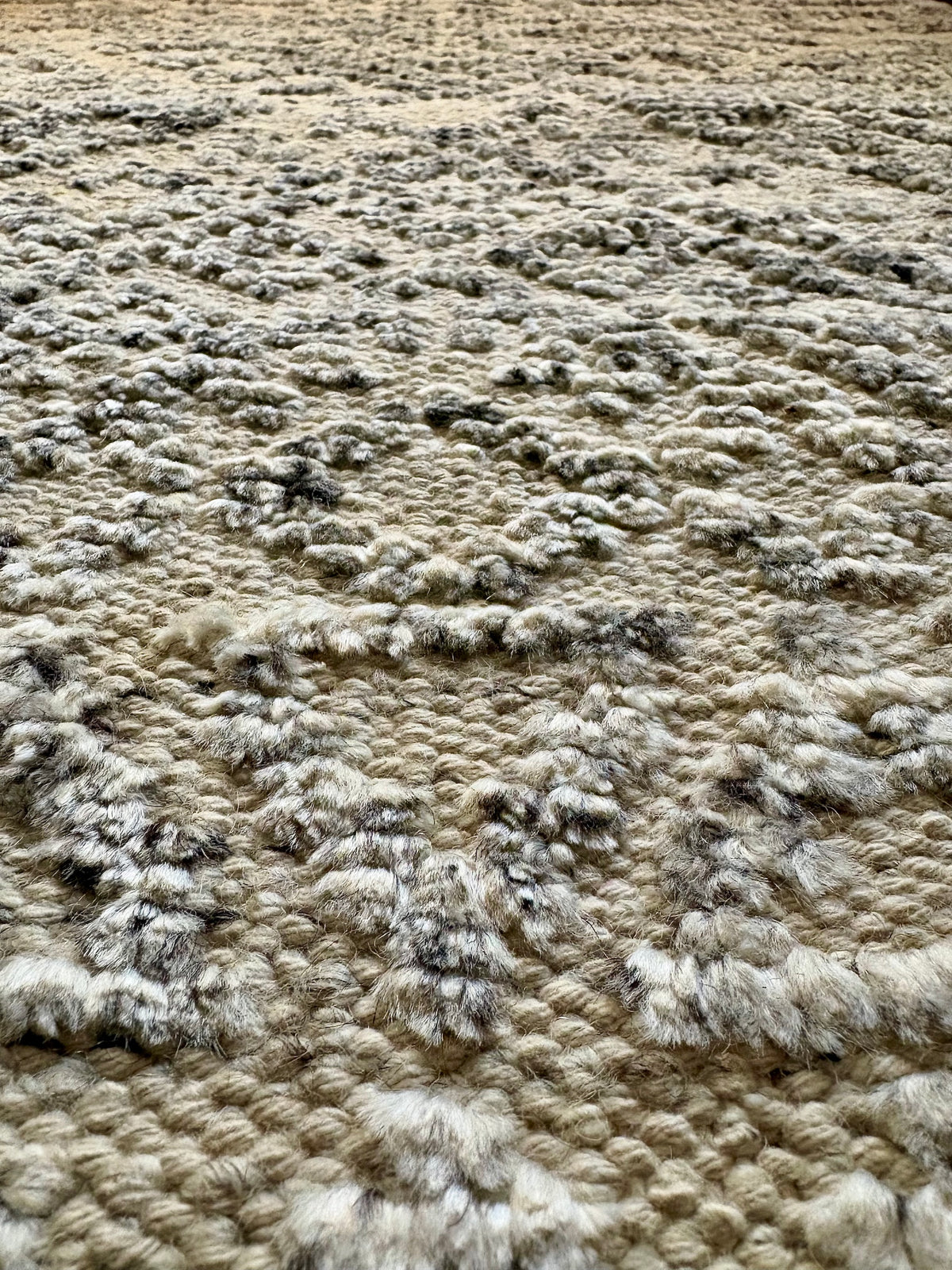 Brazil Frost modern hand-knotted rug in a wool and viscose blend with a geometric design and 7-9mm pile. White with light grey and dark grey accents. Sizes 160 x 230, 200 x 290 and 240 x 340 cm. Super close angle view.