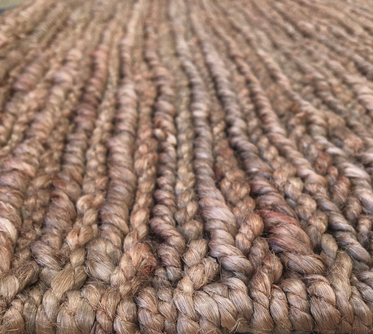 Byron Coffee hand-woven hemp rug in a braided-style flatweave. Brown. Sizes 155 x 225, 200 x 290 and 240 x 320 cm. Angle close view.