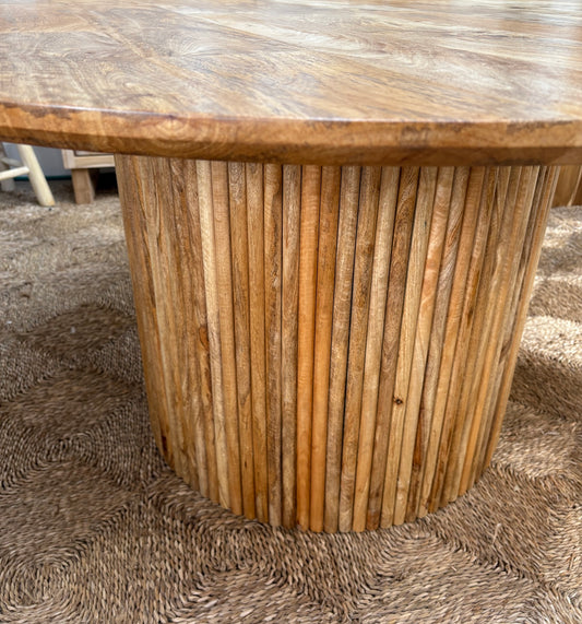 The Charles 1500 Dining Table is a contemporary round dining table. Featuring a sustainable Fruitwood top and slated column fruitwood base. Colour natural. Measures 1500 diameter X 760 height. Angle.