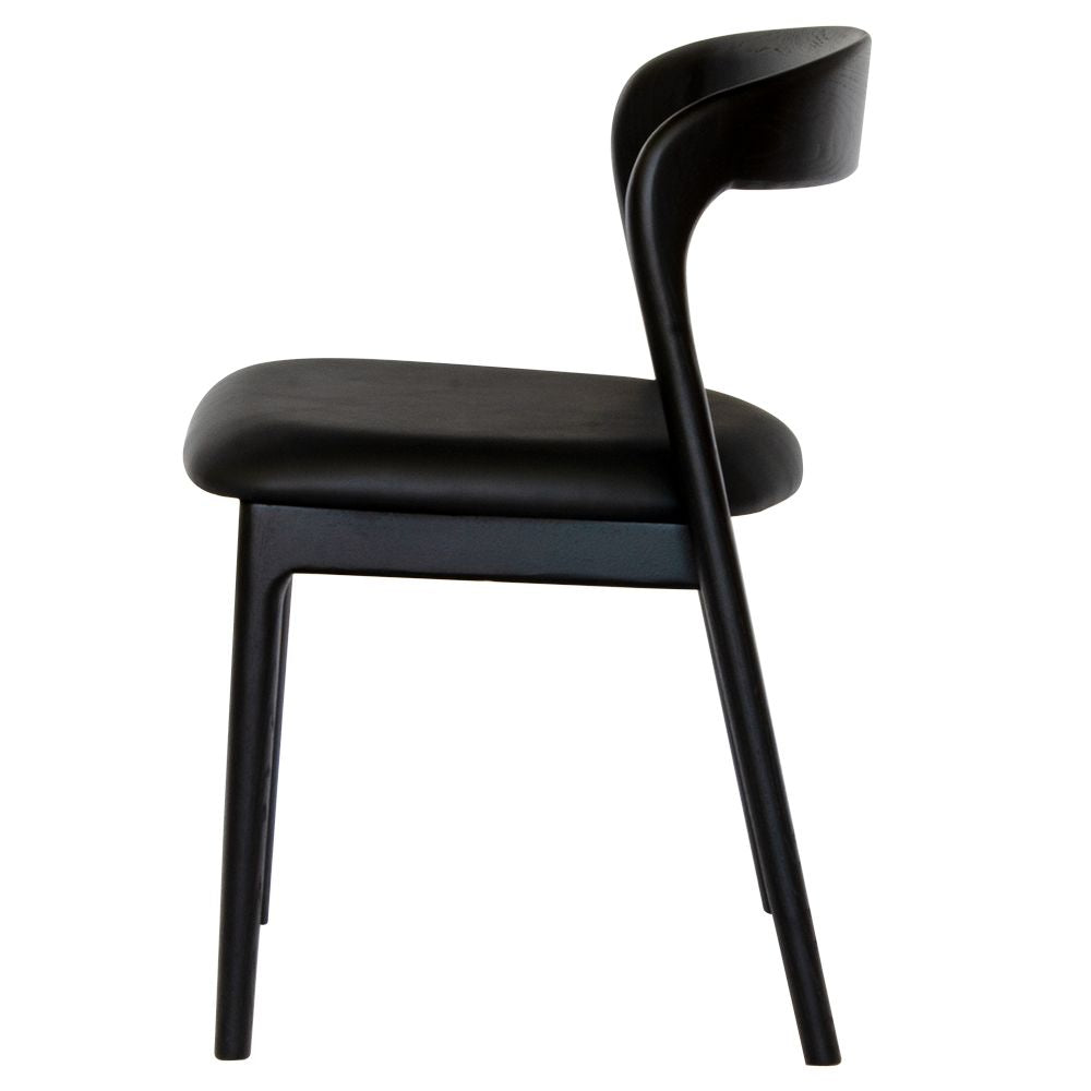 The Cheyenne Black dining chair features a modern style and design. Crafted with a solid ash frame and a smooth padded grey polyurethane seat. Colour Black Frame with black seat. Measures 500 wide X 520 depth X 460 Seat height. Back height 750. Side.