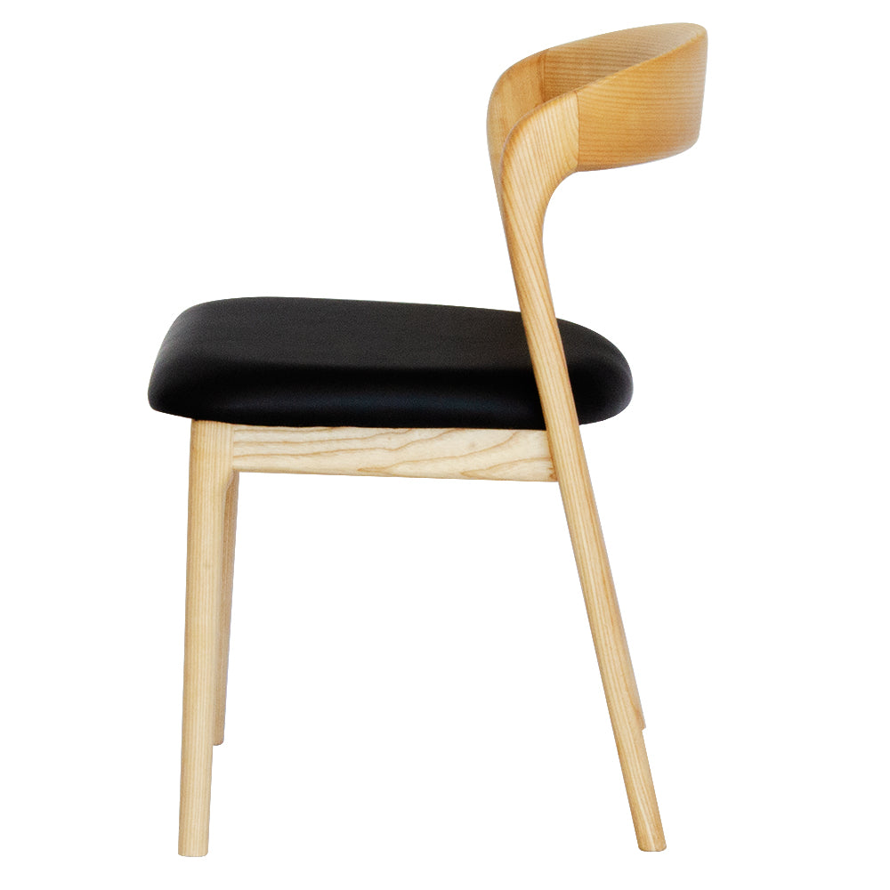 The Cheyenne Natural and Black dining chair features a modern style and design. Crafted with a solid ash frame and a smooth padded black polyurethane seat. Colour Natural Frame with Black seat. Measures 500 wide X 520 depth X 460 Seat height. Back height 750. Side.