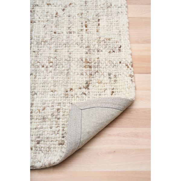 Cleo Beige hand-woven wool flatweave rug in an oatmeal neutral, with a flecked, cross-woven texture and flat woven border. 3 Sizes. Fold view.