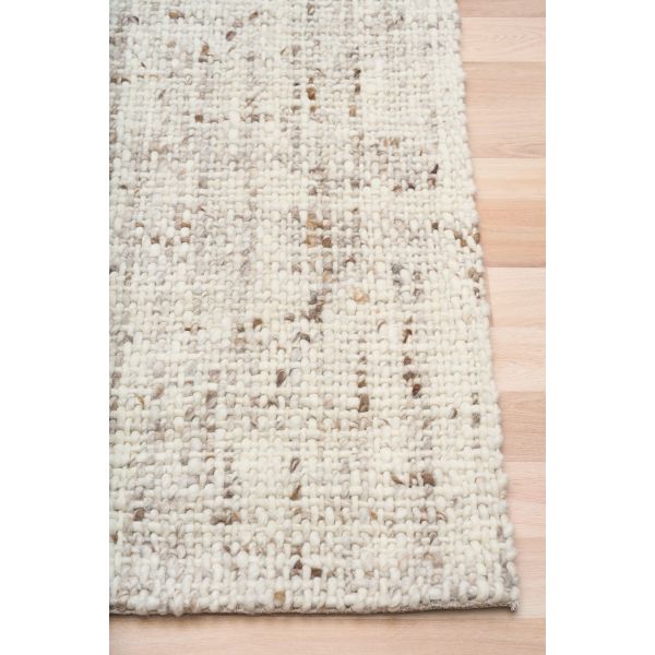 Cleo Beige hand-woven wool flatweave rug in an oatmeal neutral, with a flecked, cross-woven texture and flat woven border. 3 Sizes. Corner view.