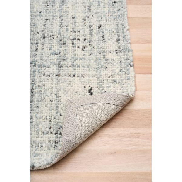 Cleo Blue hand-woven wool flatweave rug in a soft blue-grey tone, with a flecked, cross-woven texture and flat woven border. 3 Sizes. Fold view.