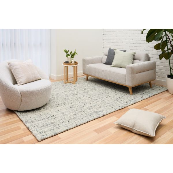Cleo Blue hand-woven wool flatweave rug in a soft blue-grey tone, with a flecked, cross-woven texture and flat woven border. 3 Sizes. Life view.