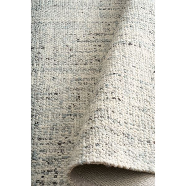 Cleo Blue hand-woven wool flatweave rug in a soft blue-grey tone, with a flecked, cross-woven texture and flat woven border. 3 Sizes. Roll view.