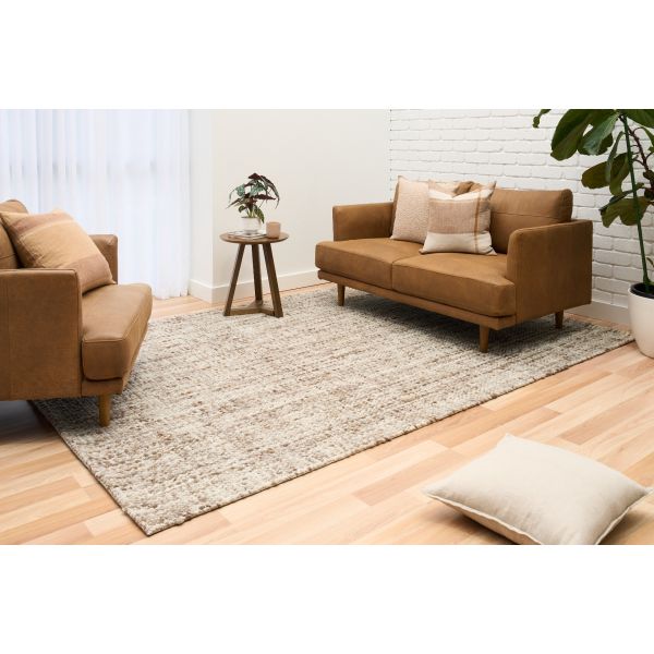 Cleo Brown hand-woven wool flatweave rug in a warm rust tone, with a flecked, cross-woven texture and flat woven border. 3 sizes. Life view.