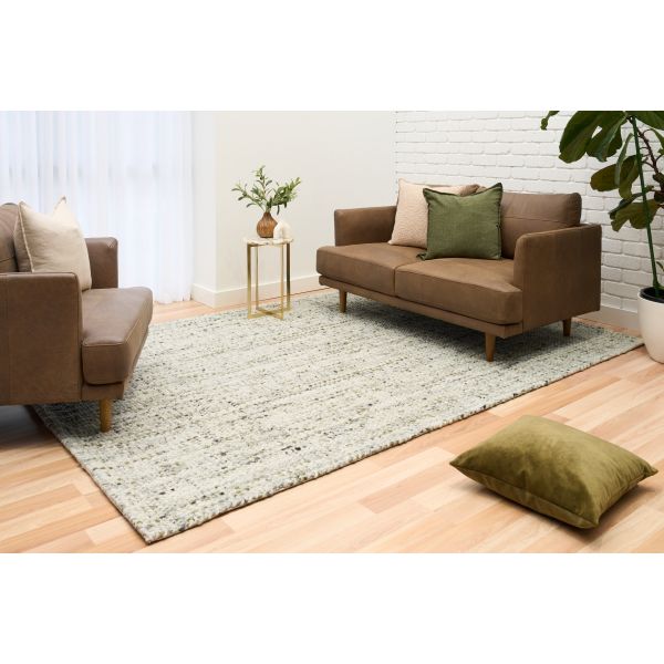Cleo Green hand-woven wool flatweave rug in a muted olive tone, with a flecked, cross-woven texture and flat woven border. 3 Sizes. Life view.