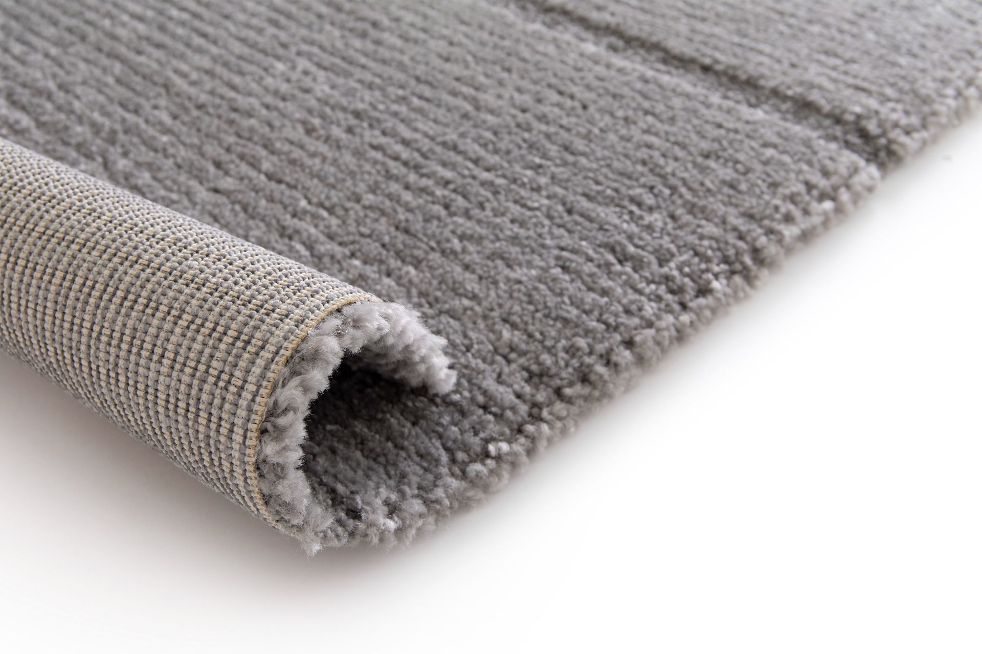 Cocoon - Grey, a modern rug design crafted with a unique blend of Heat Set Polypropylene and Polyester shrink yarn. Roll.