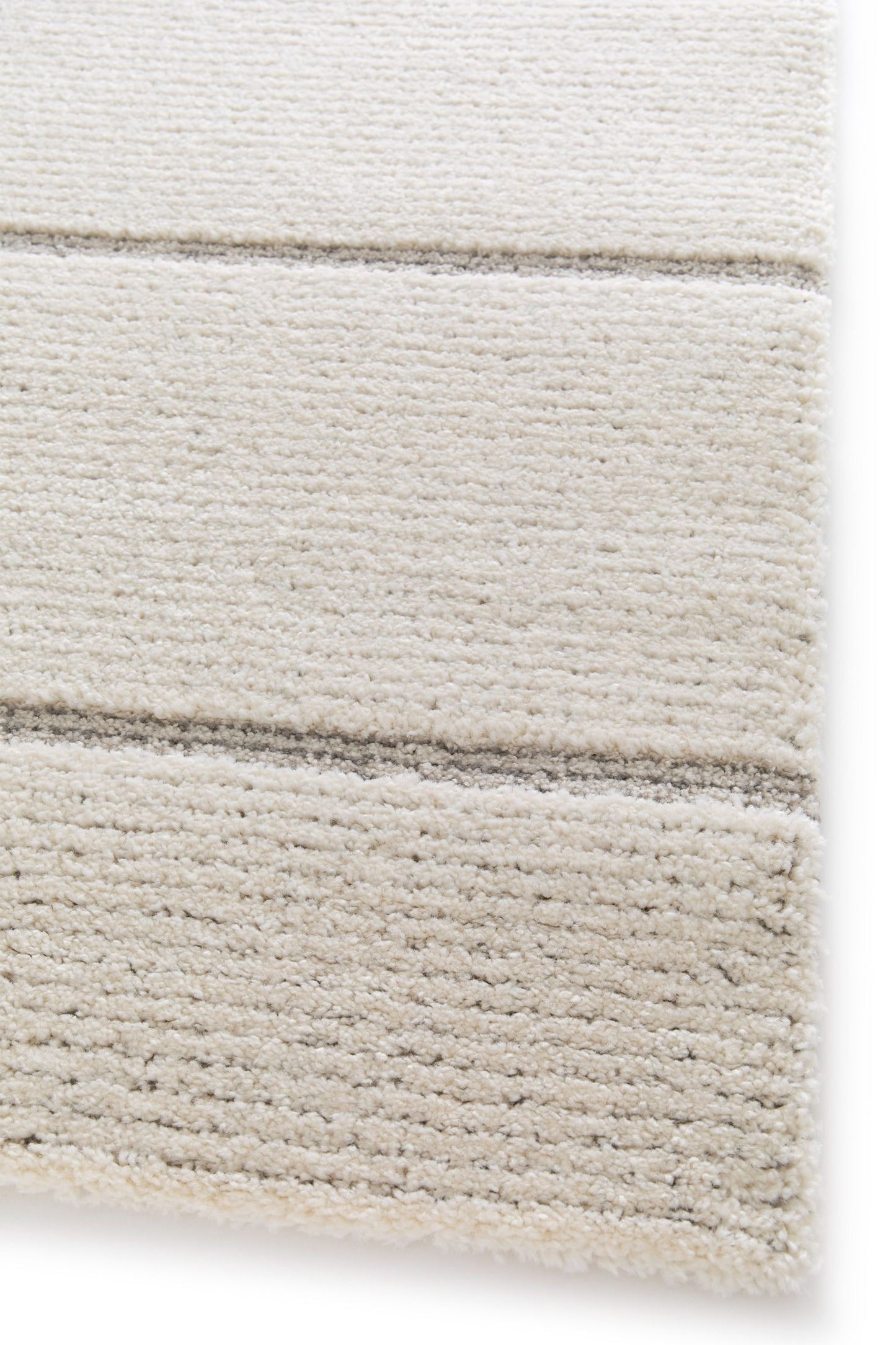Cocoon - Light Grey, a modern rug design crafted with a unique blend of Heat Set Polypropylene and Polyester shrink yarn. Corner.