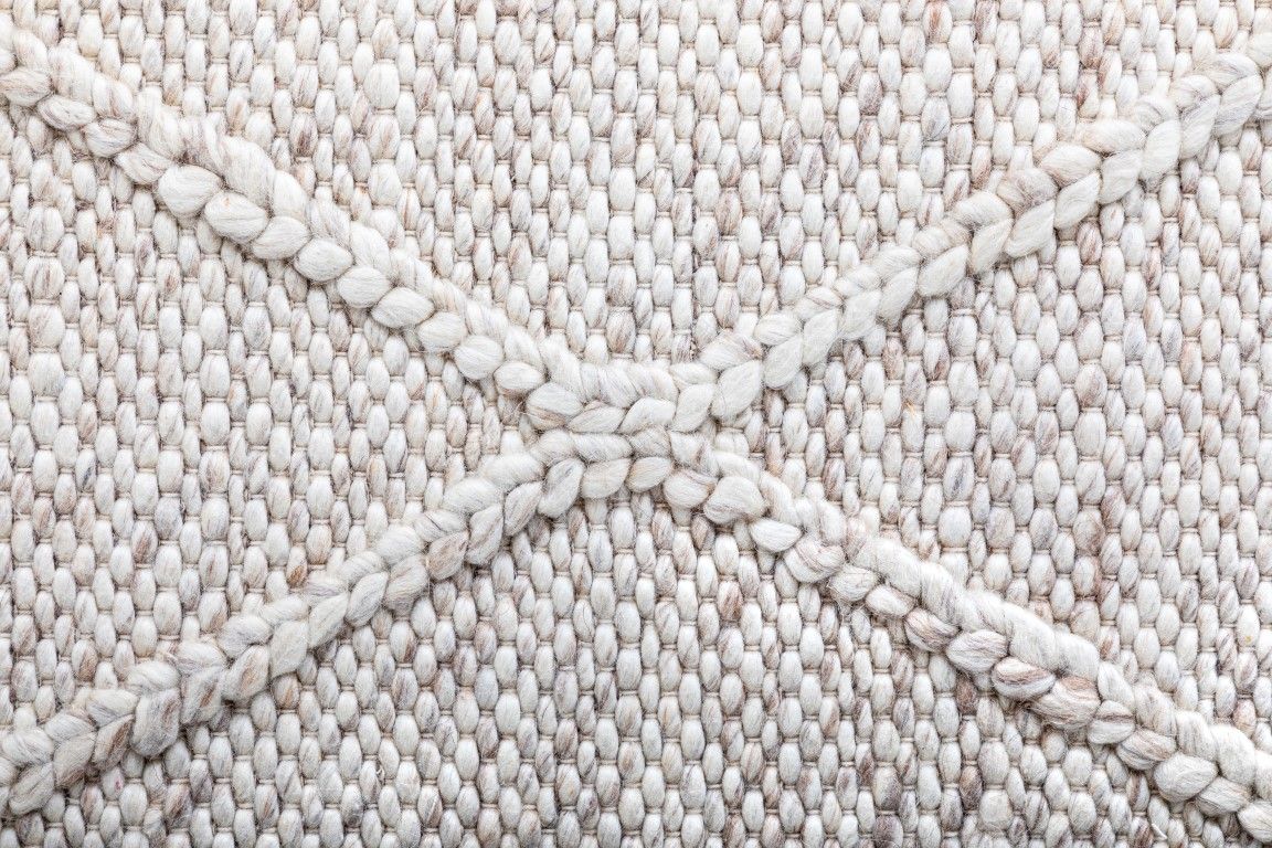 Colombo Beige is a textured hand woven rug. Made from 80% wool and 20% polyester, it features a braided diamond pattern for an extra textured feel.  Colour Beige.  Sizes 155 X 225, 200 X 290, 240 X 320 and 300 X 400. Close.