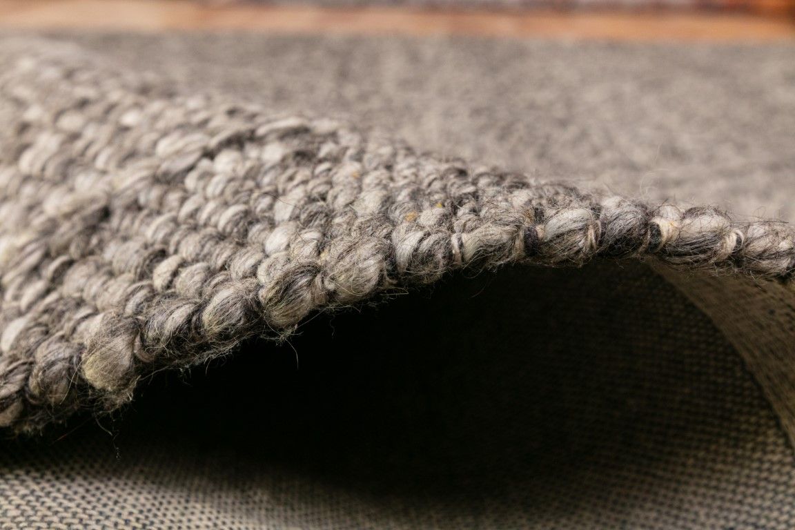 Colombo Dark Grey is a textured hand woven rug. Made from 80% wool and 20% polyester, it features a braided diamond pattern for an extra textured feel.  Colour Dark Grey.  Sizes 155 X 225, 200 X 290, 240 X 320 and 300 X 400. Side.