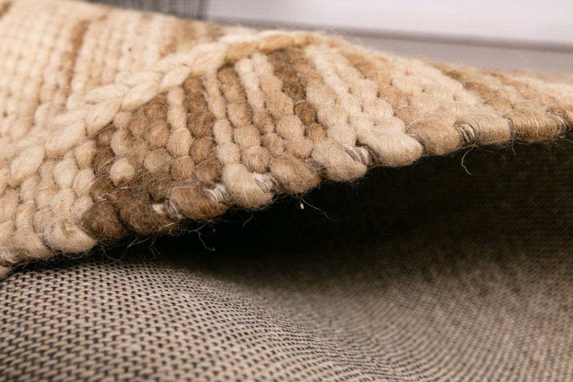 Colombo Natural is a textured hand woven rug. Made from 80% wool and 20% polyester, it features a braided diamond pattern for an extra textured feel.  Colour Creamy Beige with Brown accents.  Sizes 155 X 225, 200 X 290, 240 X 320 and 300 X 400. Side.
