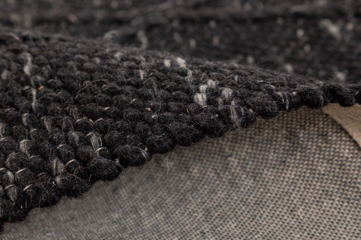 The Colombo Runner - Graphite is a textured hand woven hallway runner rug. Made from 80% wool and 20% polyester, it features a braided diamond pattern for an extra textured feel.  Colour Graphite. Size 80 wide x 320 Length. Fold.