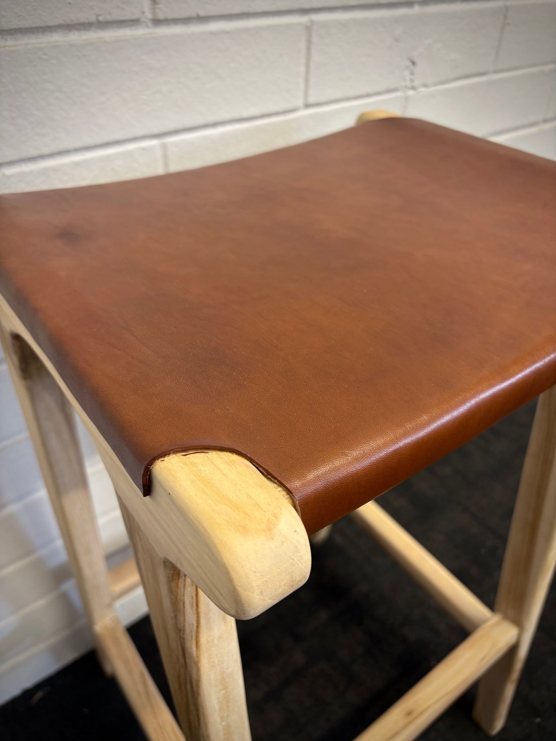 The Columbia - Brown Leather barstool features a lush leather seat and sustainable teak framed legs. Colour natural teak frame with brown leather seat. Measures 400 wide X 400 depth X 650 Seat height. Close.