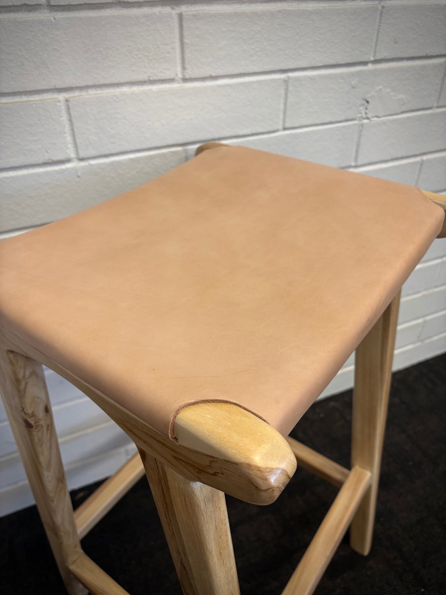 The Columbia - Natural Leather barstool features a lush leather seat and sustainable teak framed legs. Colour natural teak frame with light natural seat. Measures 400 wide X 400 depth X 650 Seat height. Angle.