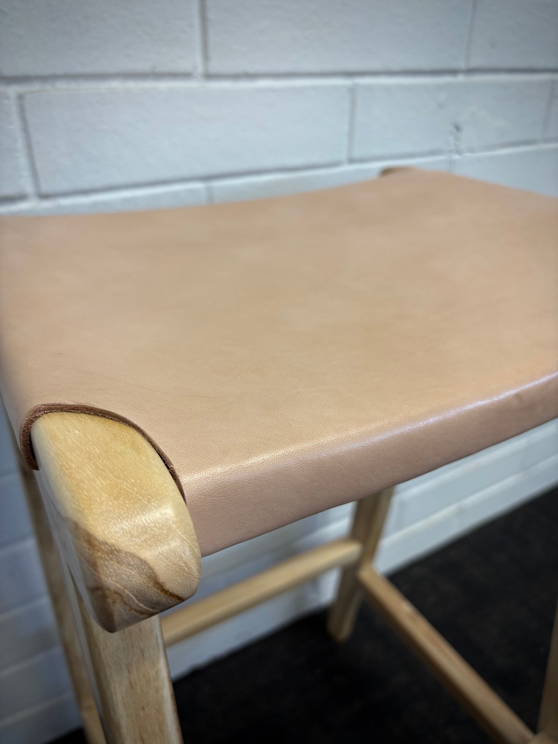 The Columbia - Natural Leather barstool features a lush leather seat and sustainable teak framed legs. Colour natural teak frame with light natural seat. Measures 400 wide X 400 depth X 650 Seat height. Close.