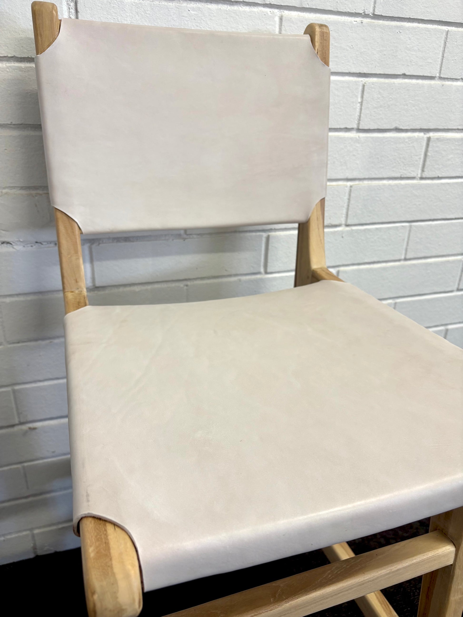 The Columbia with Back - White Leather barstool features a white leather seat and back with sustainable teak framed legs. Colour natural teak frame with white leather seat and back. Measures 400 wide X 400 depth X 680 Seat height X 1000 Back height. Close.