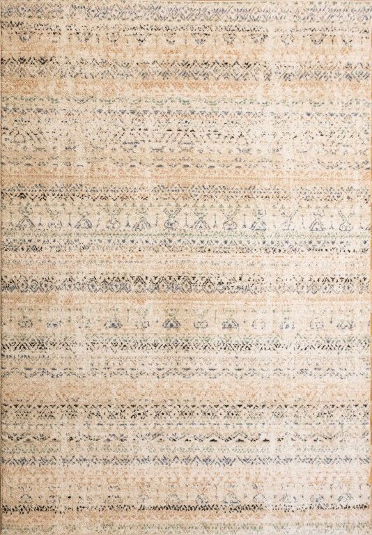 Cozy 5426 Ivory Beige is a tribal patterned designed machine made rug. Constructed from luxurious polyester yarn, it features a soft feel.  Colours Beige with Cream, Blue and Black Tribal Patterns. Size 160 X 230, 200 X 290 and 300 X 400. Full.