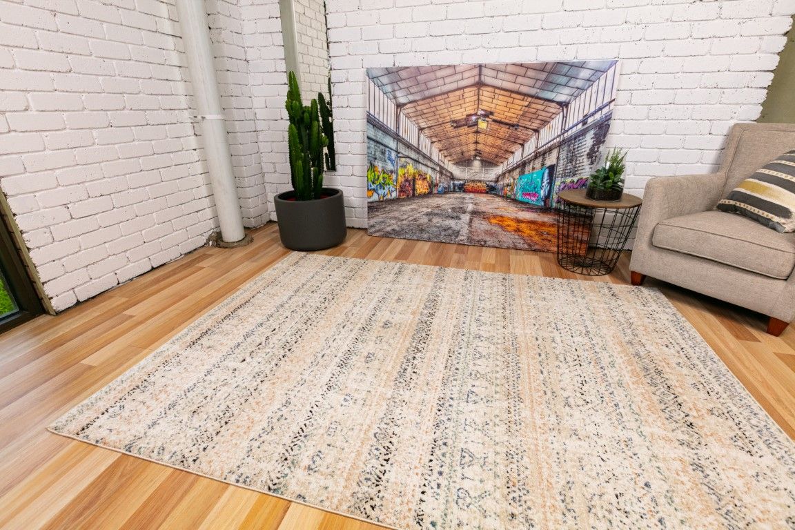 Cozy 5426 Ivory Beige is a tribal patterned designed machine made rug. Constructed from luxurious polyester yarn, it features a soft feel.  Colours Beige with Cream, Blue and Black Tribal Patterns. Size 160 X 230, 200 X 290 and 300 X 400. Life.