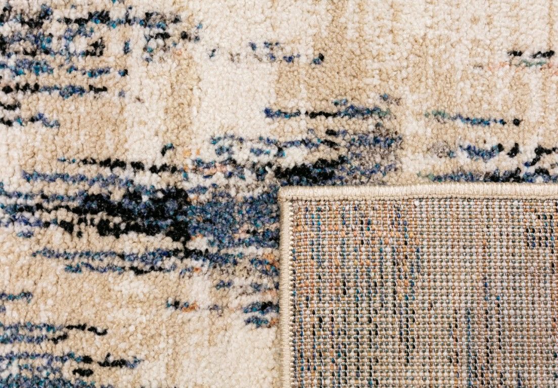 Cozy 5439 Blue Beige is a tribal diamond patterned designed machine made rug. Constructed from luxurious polyester yarn, it features a soft feel.  Colours Beige with Cream, Blue and Black Diamond Patterns. Sizes  160 X 230 and 200 X 290 and 300 X 400. Fold.