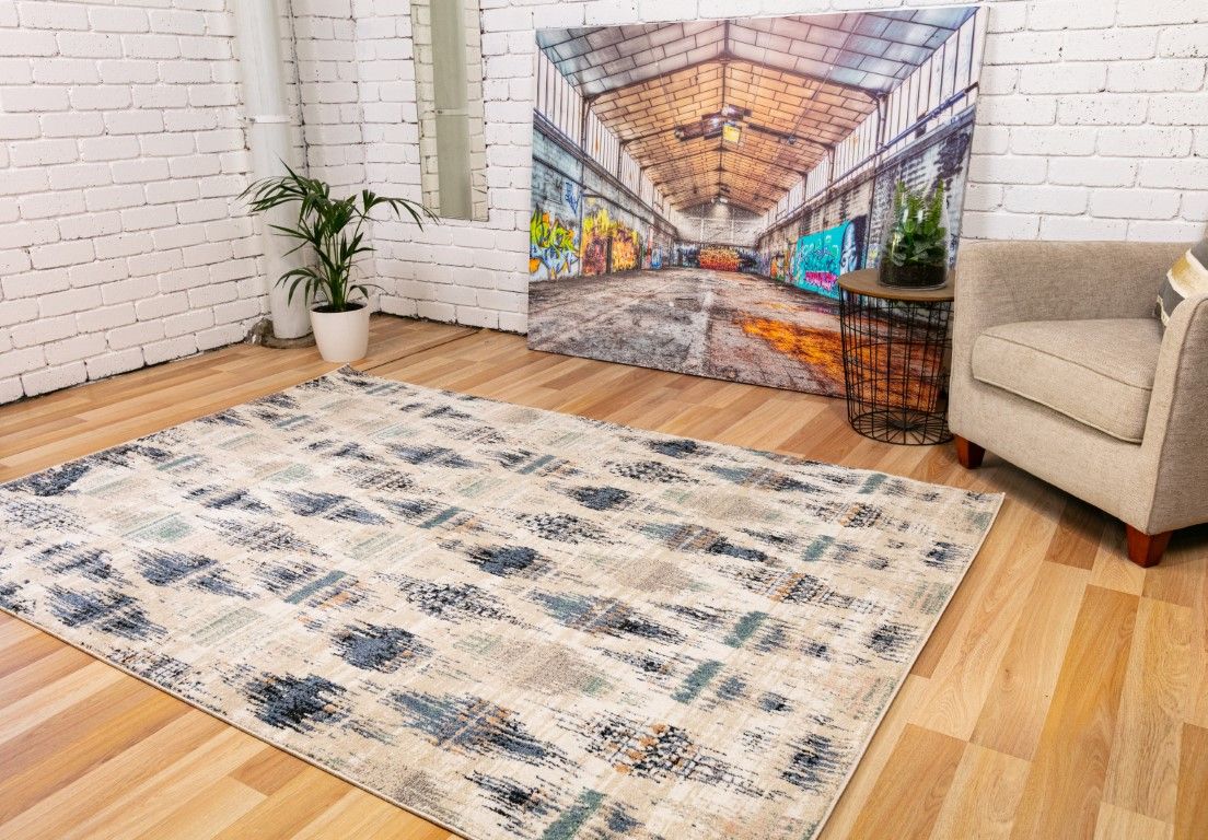 Cozy 5439 Blue Beige is a tribal diamond patterned designed machine made rug. Constructed from luxurious polyester yarn, it features a soft feel.  Colours Beige with Cream, Blue and Black Diamond Patterns. Sizes  160 X 230 and 200 X 290 and 300 X 400. Life.