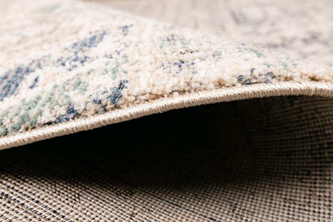 Cozy 5443 Dark Beige is a tribal diamond patterned designed machine made rug. Constructed from luxurious polyester yarn, it features a soft feel.  Colours Beige with Cream, Blue and Black  Tribal Diamond Patterns. Sizes 160 X 230 and 300 X 400. Side.