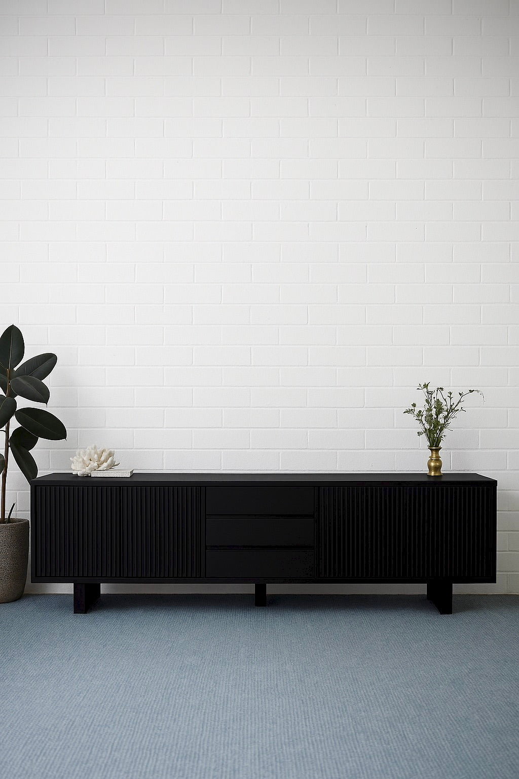 The Crosby Black Entertainment Unit, featuring 4 Sliding Doors and 3 drawers. This entertainment unit boasts a modern design and ample storage. Crafted from solid white cedar. Colour Black. Measures 2500 Length x 400 Depth x 600 Height. Styled.