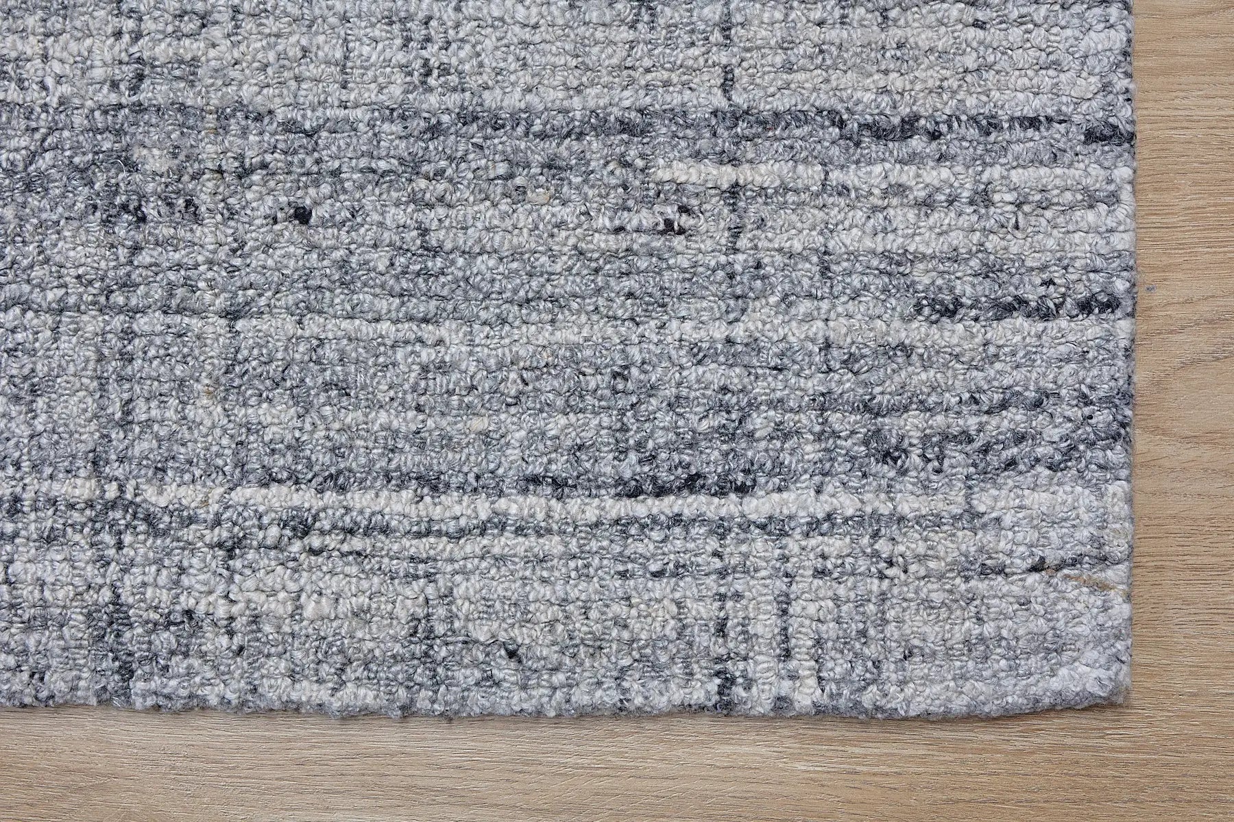 Crown - Black is a Modern/Contemporary textured hand tufted Wool and Polyester rug with a pile height of 12-14mm. Colours Light Grey with Black and Grey accents. Sizes 160 X 230, 200 X 290, and 240 X 340. Corner.