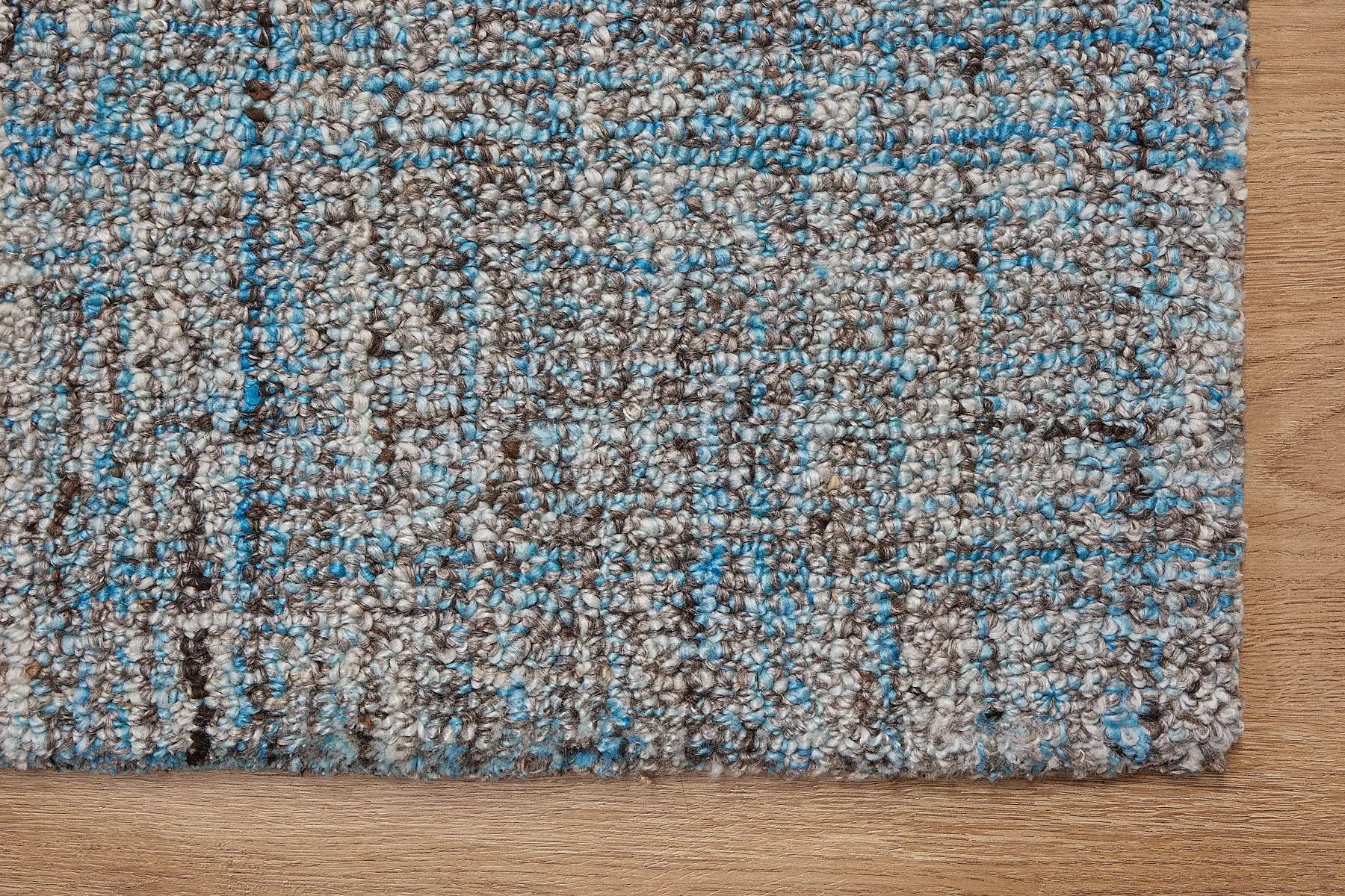 Crown - Blue is a Modern/Contemporary textured hand tufted Wool and Polyester rug with a pile height of 12-14mm. Colours Blue with Dark Grey and Grey accents. Sizes 160 X 230, 200 X 290, and 240 X 340. Corner.