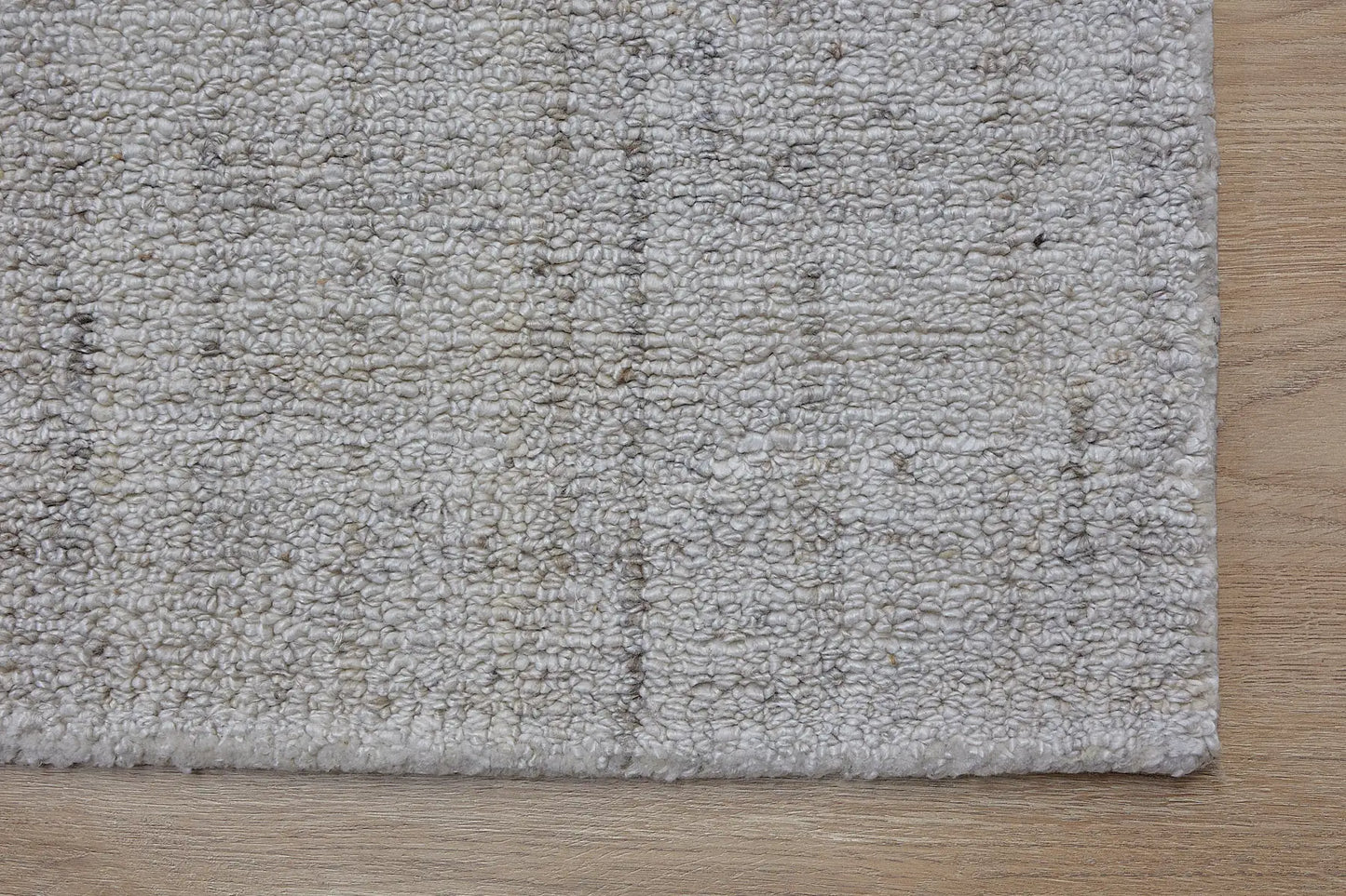 Crown - Ivory is a Modern/Contemporary textured hand tufted Wool and Polyester rug with a pile height of 12-14mm. Colours Ivory with Beige accents. Sizes 160 X 230, 200 X 290, and 240 X 340. Corner.