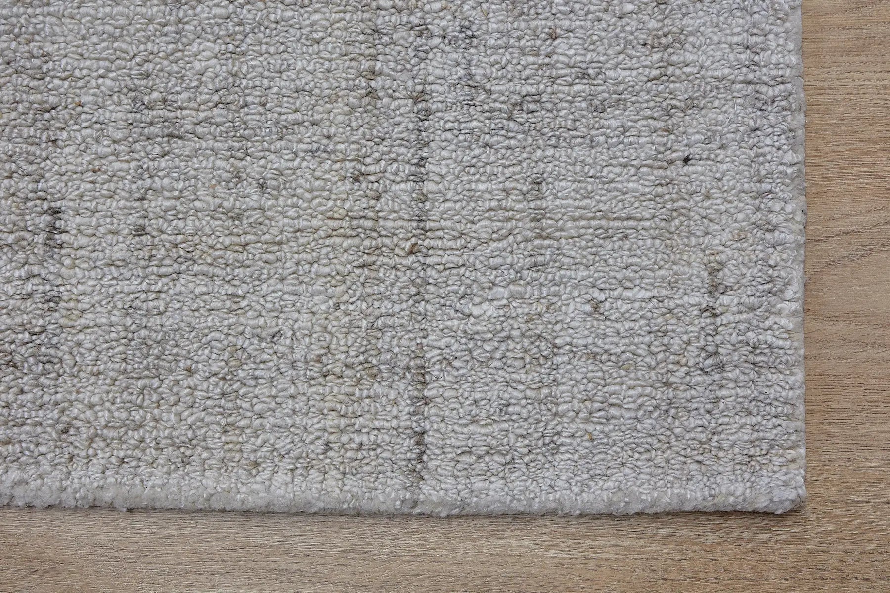 Crown - Ivory is a Modern/Contemporary textured hand tufted Wool and Polyester rug with a pile height of 12-14mm. Colours Ivory with Beige accents. Sizes 160 X 230, 200 X 290, and 240 X 340. Corner.