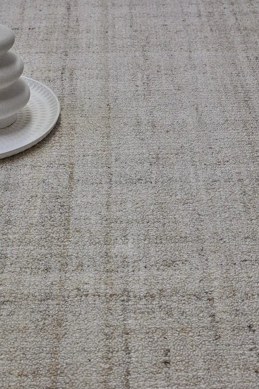 Crown - Ivory is a Modern/Contemporary textured hand tufted Wool and Polyester rug with a pile height of 12-14mm. Colours Ivory with Beige accents. Sizes 160 X 230, 200 X 290, and 240 X 340. Life.