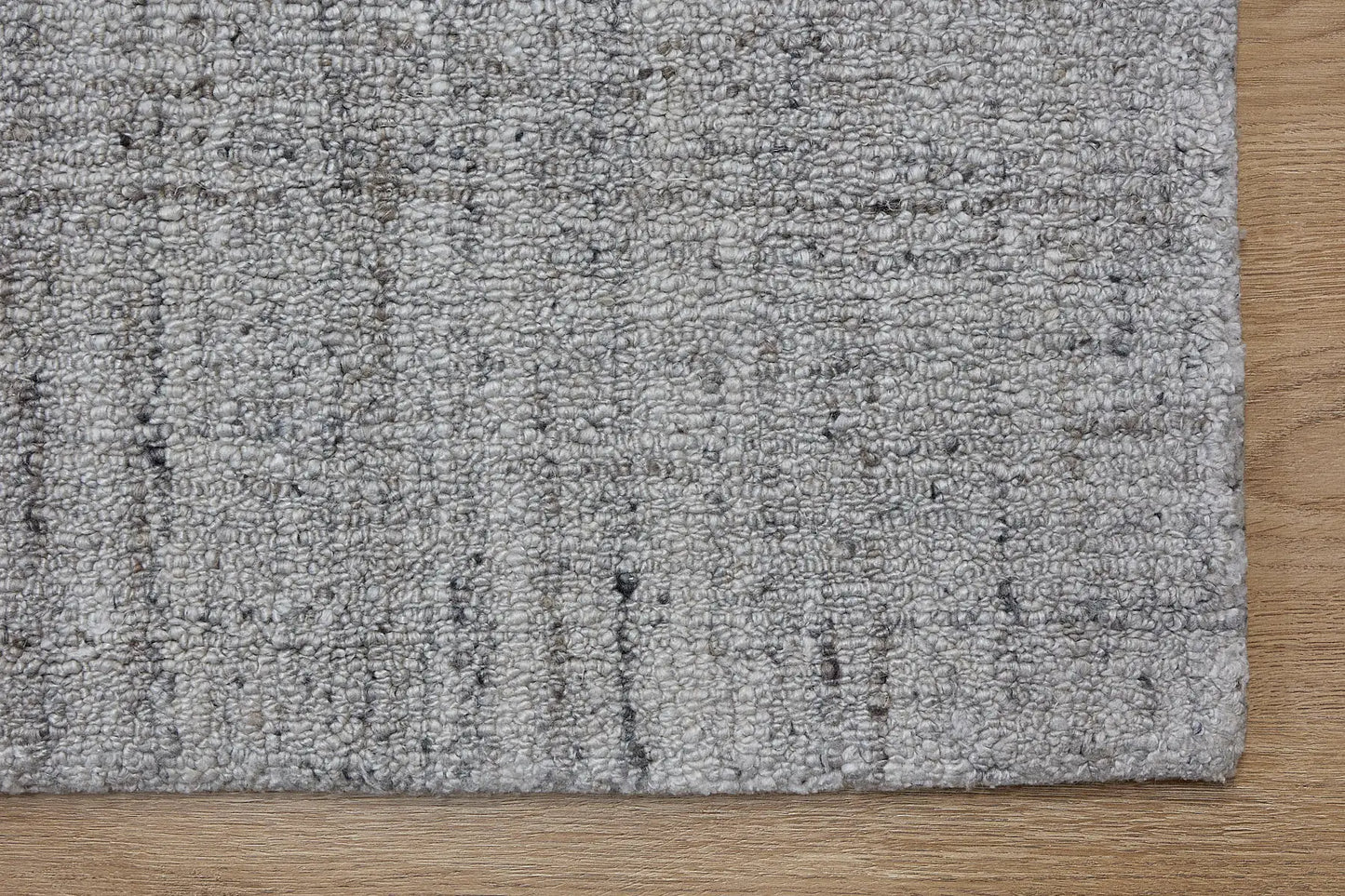 Crown - Light Grey is a Modern/Contemporary textured hand tufted Wool and Polyester rug with a pile height of 12-14mm. Colours Light Grey with Grey accents. Sizes 160 X 230, 200 X 290, and 240 X 340. Corner.