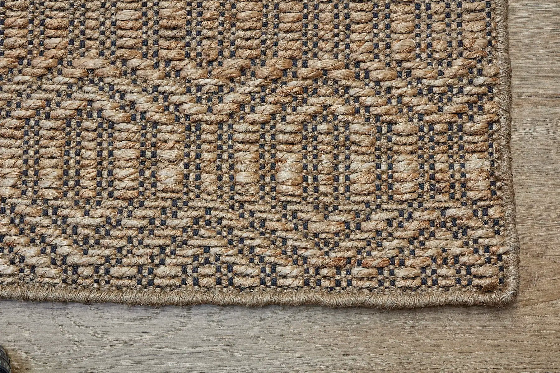 Daintree - Nevada is a rug made with panja hand woven natural coloured jute. Features a 7-9mm pile height and geometic design. Colour Natural with Black. Sizes 160 X 230, 200 X 290 and 240 X 340. Corner.