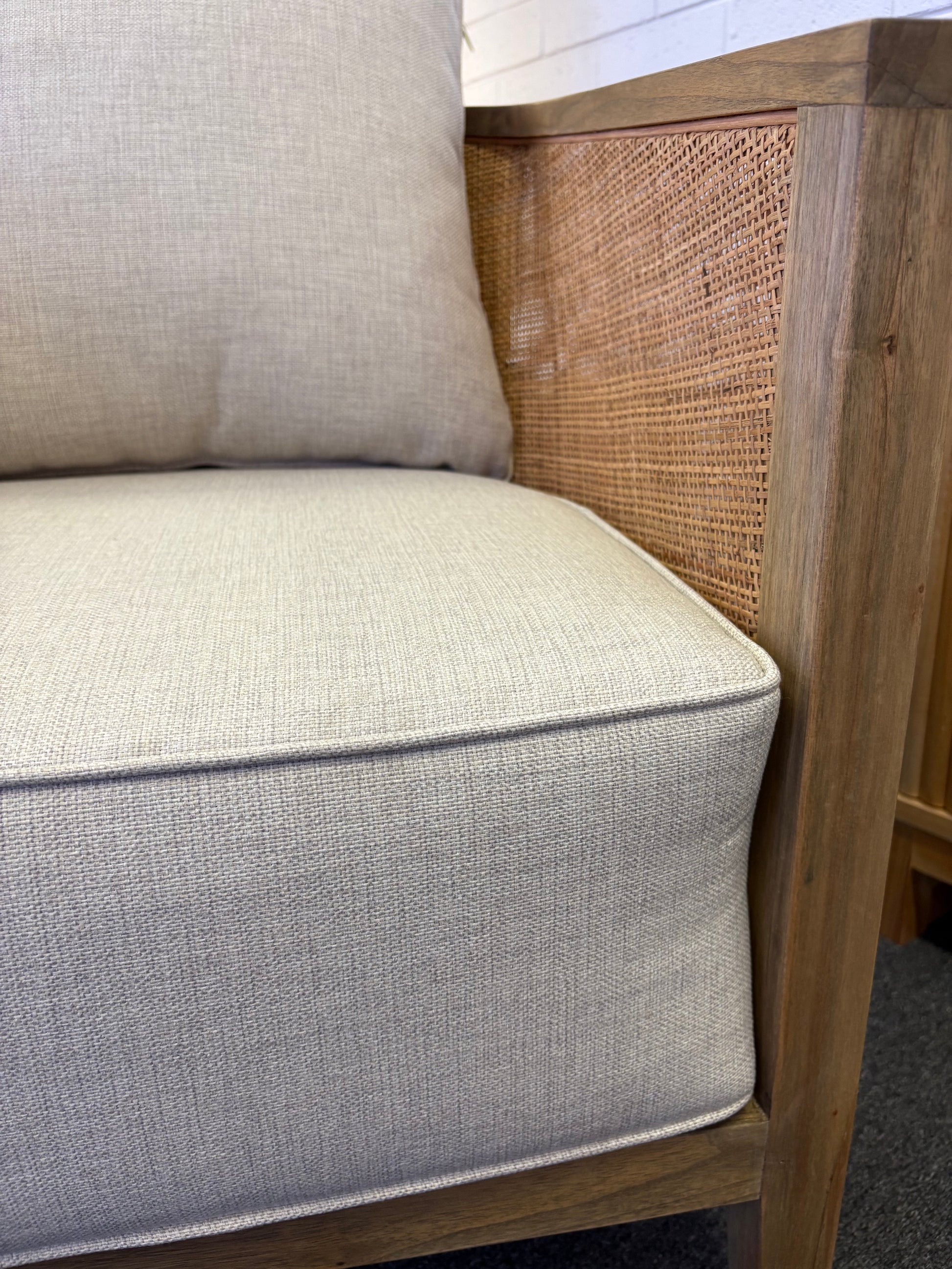 The Daisy Occasional Chair. Teak Frame wrapped in open mesh rattan. Includes cushioned seat and back. Colour Natural Teak and Rattan with cream cotton twill cushions. Measures 700 Wide X 800 Depth X 750 Back Height. Inner Side.