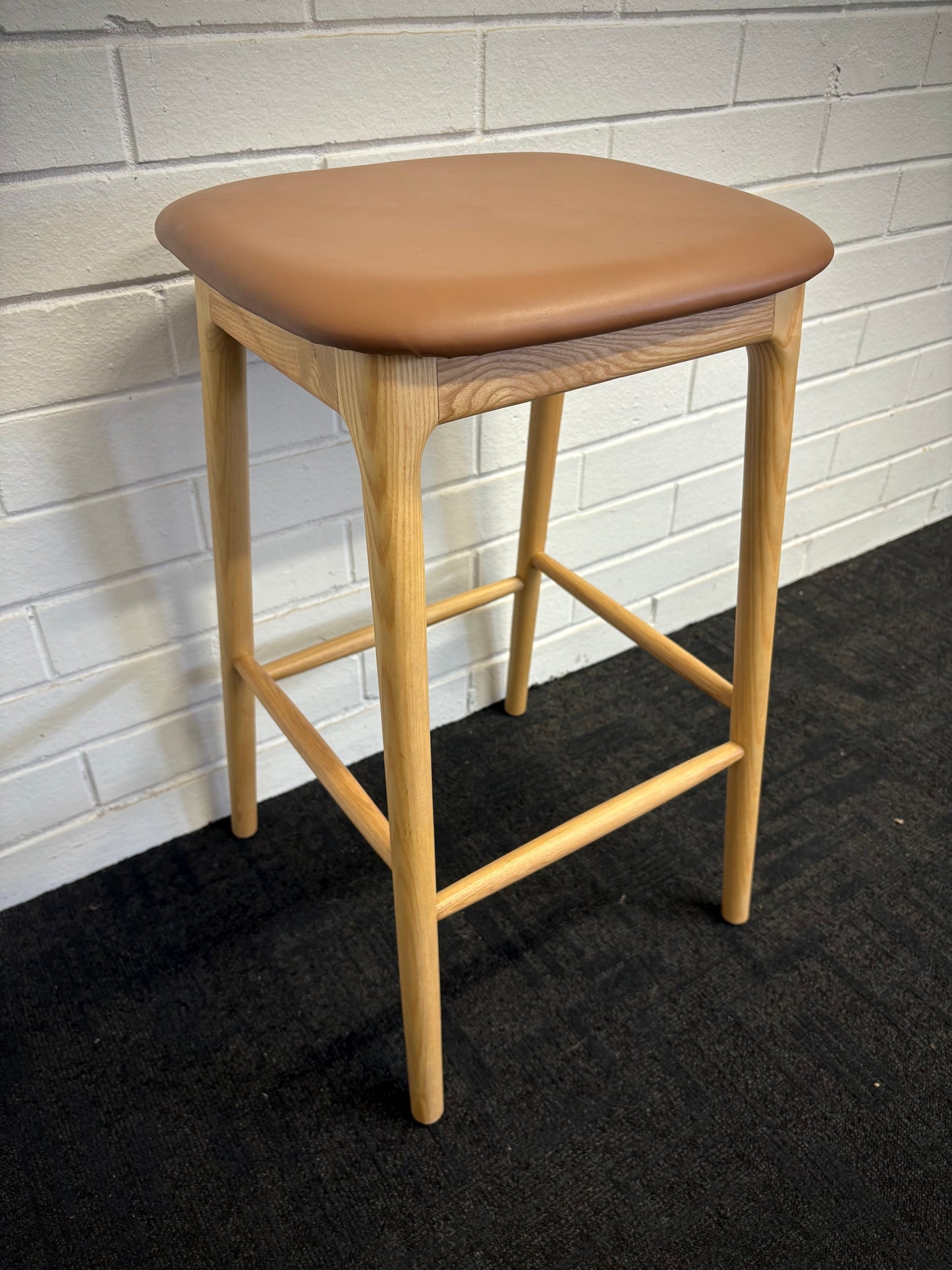 The Danube - Natural/Tan Barstool. A contemporary style barstool. Solid natural ash frame with tan polyurethane seat. Measures  400W X 400D X 670 Seat Height. Angle.