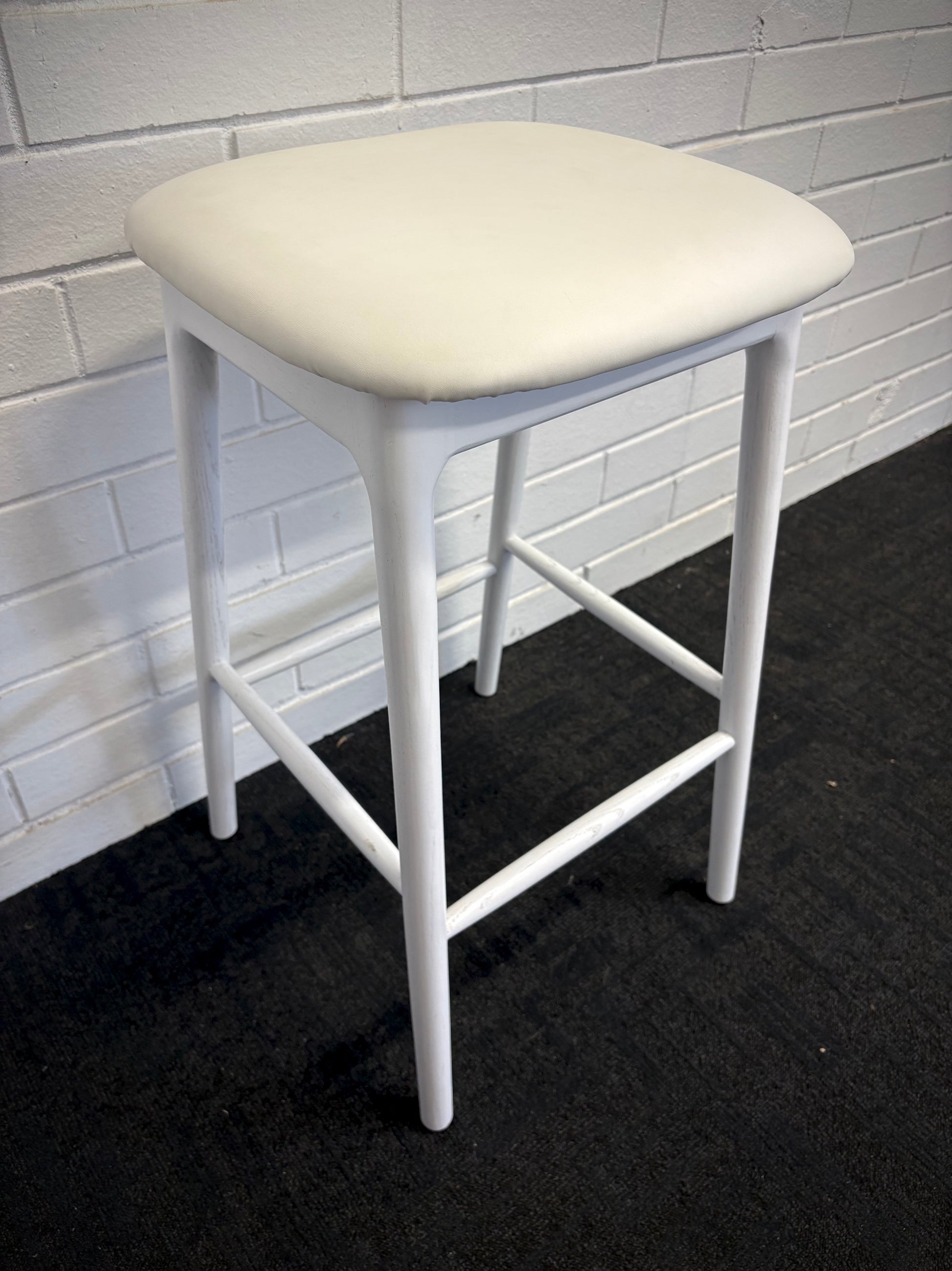 The Danube - White Barstool. A contemporary style barstool. Solid natural ash frame with tan polyurethane seat. Measures  400W X 400D X 670 Seat Height. Side.