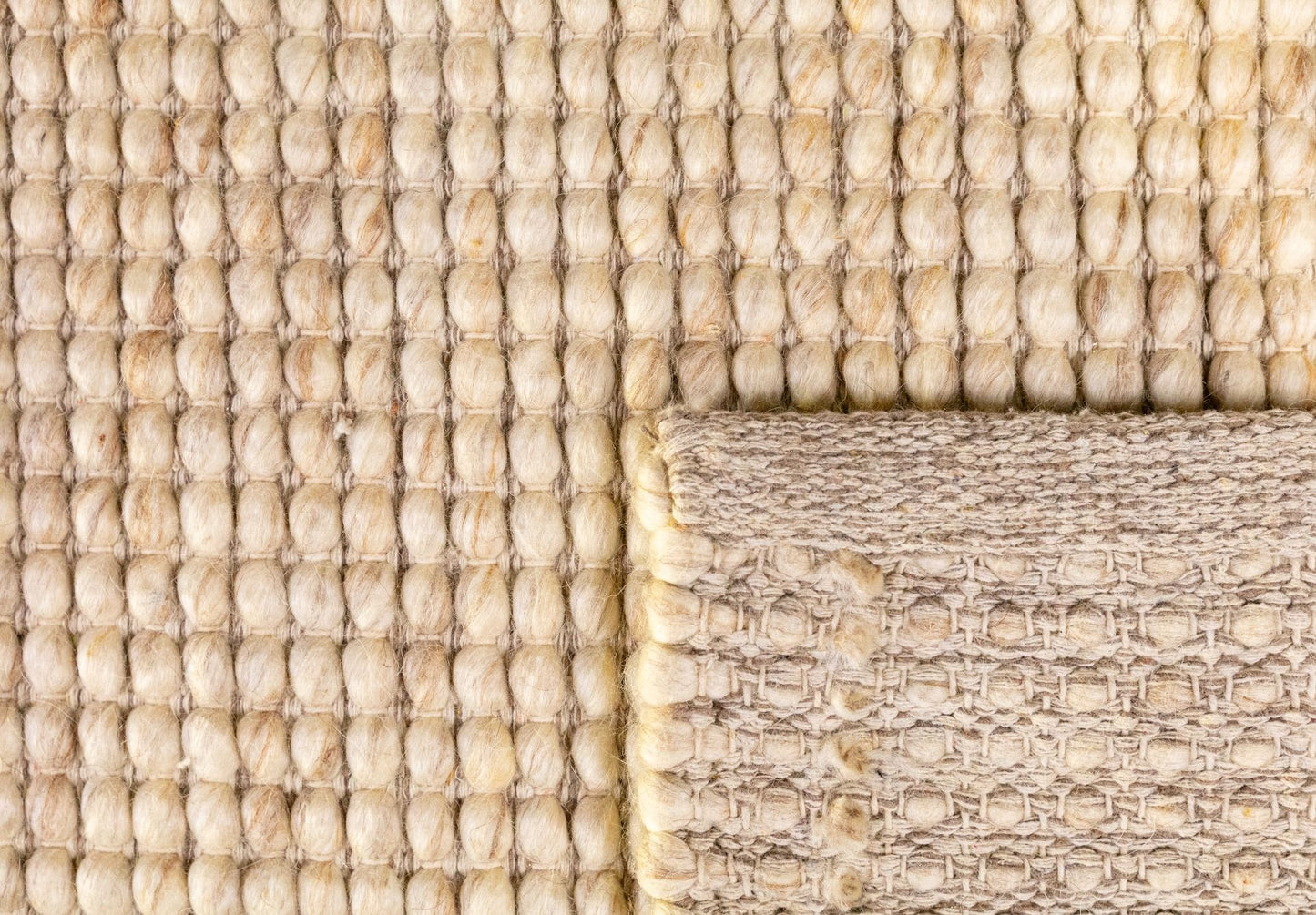 Dasha Beige is a texture hand woven rug made of 80%  New Zealand Wool and 20% Polyester. Colour Beige. Sizes 155 X 225, 200 X 290, 240 X 320 and 300 X 400. Fold.