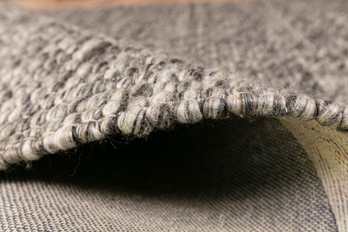Dasha Dark Grey is a texture hand woven rug made of 80%  New Zealand Wool and 20% Polyester. Colour Dark Grey. Sizes 155 X 225, 200 X 290, 240 X 320 and 300 X 400. Side.
