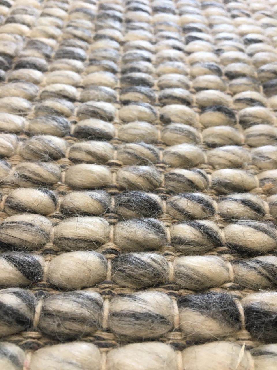 Dasha Grey is a texture hand woven rug made of 80%  New Zealand Wool and 20% Polyester. Colour Grey. Sizes 155 X 225, 200 X 290, 240 X 320 and 300 X 400. Angle.